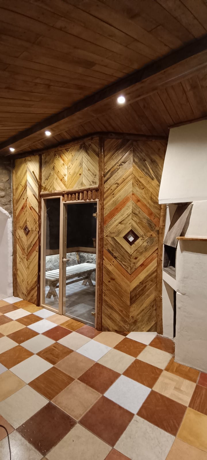 Herringbone wood interior with glass door entrance to Sauna Temple